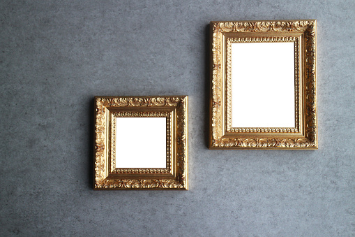 A set of two ornate gold picture frames with room for your images.