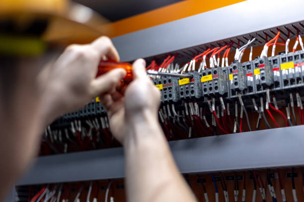 Engineering hand is screwing on the contactor in repair and maintenance concept.