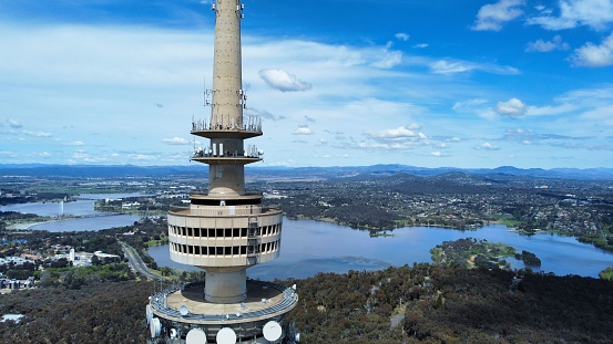 Canberra, Australia – December 19, 2022: An aerial view of Telstra Tower with lake and city view background
