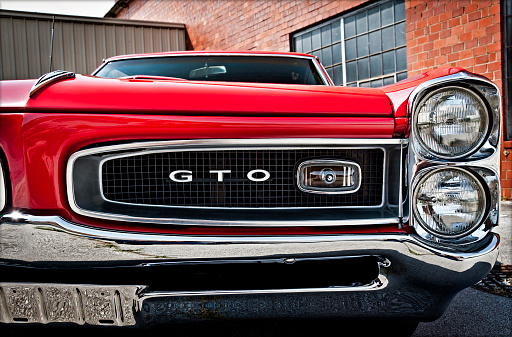 Maryville, Tennessee, United States - May 12, 2011: A wonderfully-detailed close-up of a red 1966 Pontiac GTO muscle car.