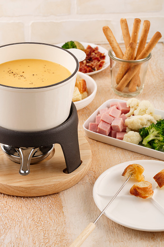 Swiss cheese fondue with bread and other ingredients.