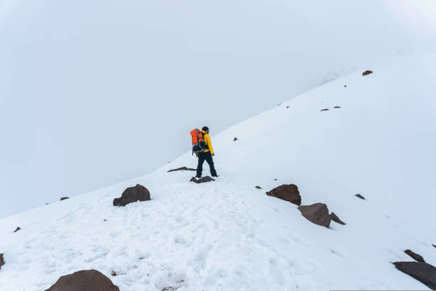 istock Man with backpack trekking in mountains 1450731708