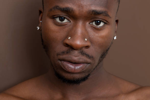 istock Fit, African black man looking at camera in front of brown wall. 1450744421