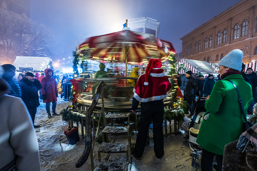 Riga, Latvia - December 17, 2022: People at Christmas market in the Dome square in the center of old Riga, Latvia.
