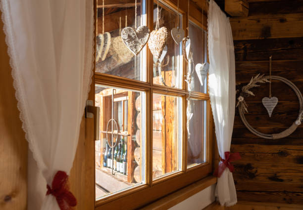istock Mountain hut window with white curtains and Christmas decorations on a clear winter day, Austria, Salzburg 1450751200