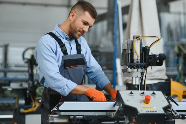 istock Factory for aluminum and PVC windows and doors production. Manual worker assembling PVC windows and doors 1450751246