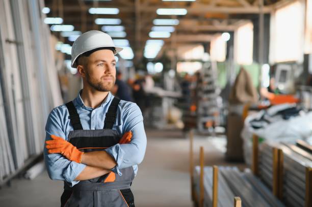 istock Factory for aluminum and PVC windows and doors production. Manual worker assembling PVC windows and doors. 1450751674
