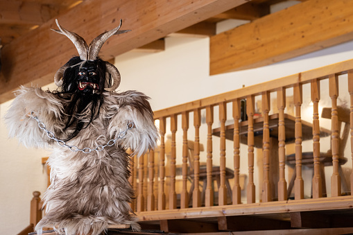 Life-size puppet of Krampus, a Christmas devil, in the hall of a mountain restaurant, Austria, Salzburg. High quality photo