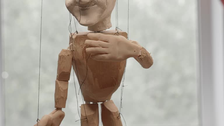 Handmade puppet doll on the strings close up