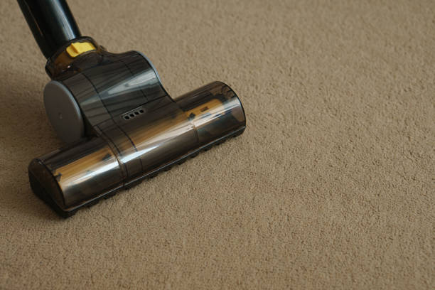 istock Vacuum cleane nozzle on the carpet. Space for text.Close-up 1450755778