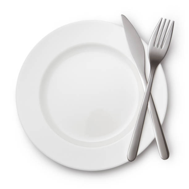 istock Knife and fork crossed on white plate, on white background 1450756631