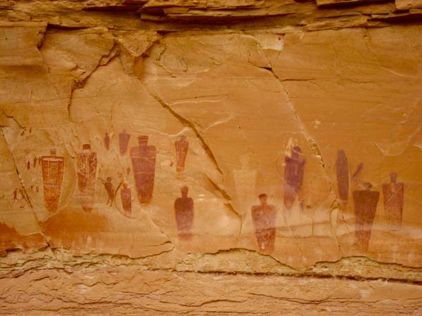 Figures at the Great Gallery in Horseshoe Canyon The famous Great Gallery in Horseshoe Canyon is 200 feet long, 15 feet high, and contains dozens of fascinating red, brown, and white pictographs. The panel is believed to be thousands of years old and was created during the late archaic period. It contains one of the finest displays and best preserved of prehistoric Indian rock art in the United States. Located in a detached unit of Canyonlands National Park in Utah, this area was added to the park in 1971 to protect this amazing collection of rock art. canyonlands national park stock pictures, royalty-free photos & images