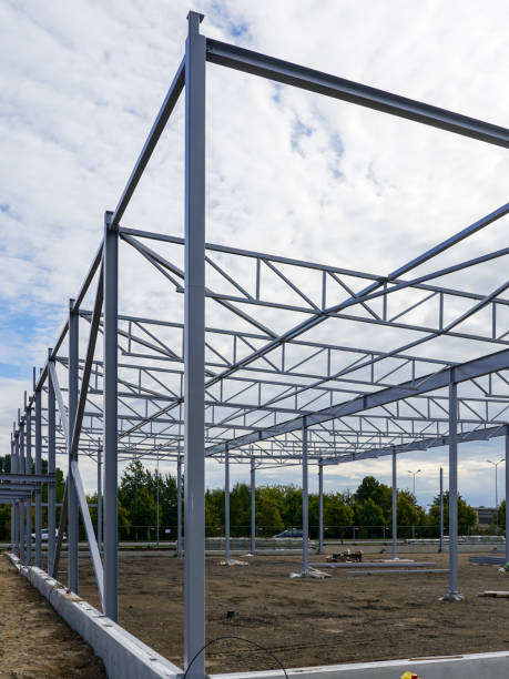istock Assembled steel framework of new modern industrial building with foundation concrete panel border 1450761501