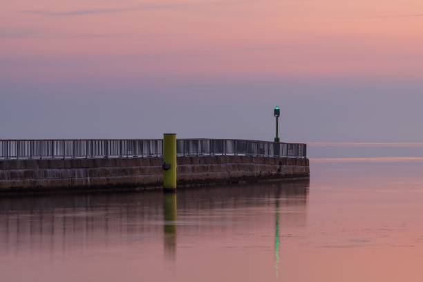 istock Mesmerizing sea view with stone pier under pinky sunset sky 1450762465