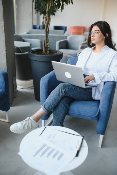 istock Beautiful Young Freelancer Woman Using Laptop Computer Sitting At Cafe Table. Happy Smiling Girl Working Online Or Studying And Learning While Using Notebook. Freelance Work, Business People Concept. 1450763705