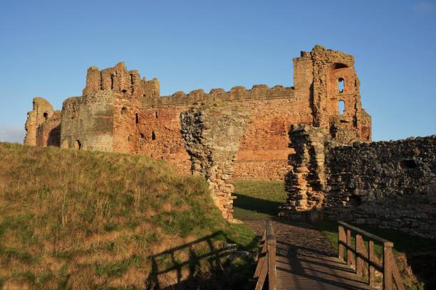 Tantallon Castle North Berwick, East Lothian, Scotland - 20 December 2022: Looking through the entrance in the surrounding wall towards Tantallon Castle in mid-winter sunshine. north berwick scotland east lothian castle scotland stock pictures, royalty-free photos & images
