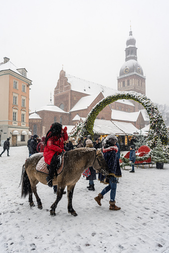 Riga, Latvia - November 26, 2022: People at Christmas market in the Dome square in the center of old Riga, Latvia.