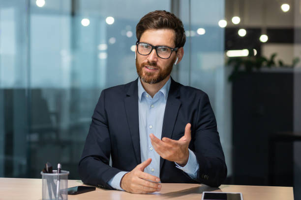 istock Webcam video call view, happy mature boss talking to colleagues remotely, man looking at camera sitting in office, investor on online meeting with partners friendly smiling and chatting 1450770224