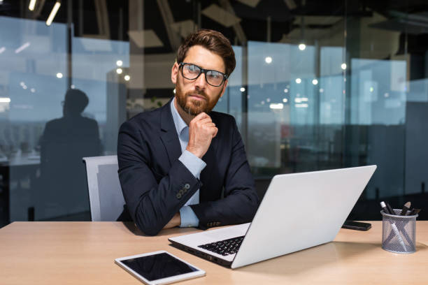 istock Serious thinking senior businessman working inside office using laptop, man in glasses solving problem, mature investor in business suit 1450770802