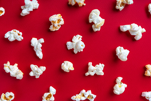 Popcorn pattern on red background. Top view, flat lay