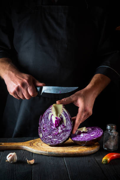 istock A professional chef cuts red cabbage with a knife. Cooking vegetable salad in the restaurant kitchen. Vegetable diet idea. 1450776413