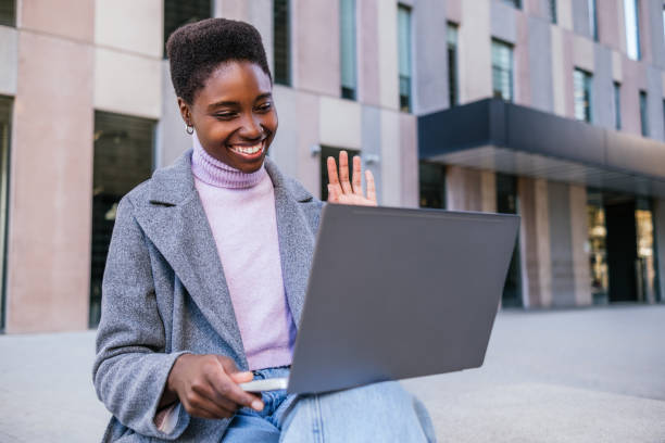 istock Glad black woman making phone call 1450778375