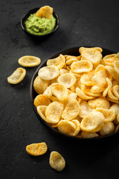 istock Fried shrimp cracker in Thai style. Shrimp cracker with avocado dip on wooden background 1450782586