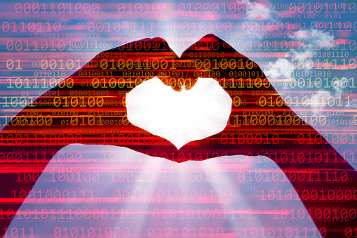 Binary code abstract background with hands making a heart shape. Space for copy.