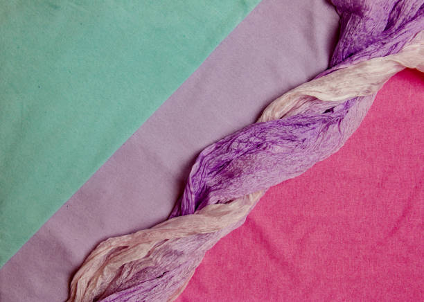 Composition of light cotton fabrics in lilac-pink colors. Background from fabrics. Textile texture.