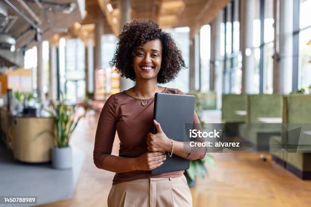 Portrait Of Happy African Businesswoman Holding Digital Tablet In The Office Stock Photo - Download Image Now