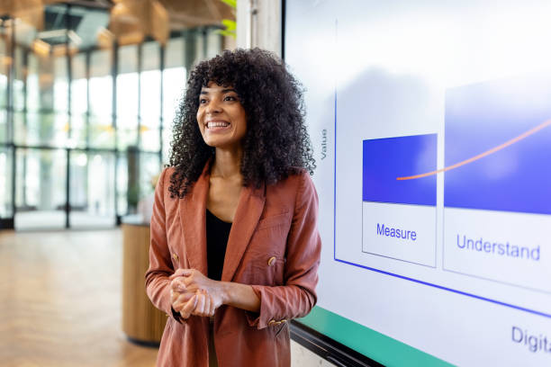 Smiling African woman giving presentation at startup