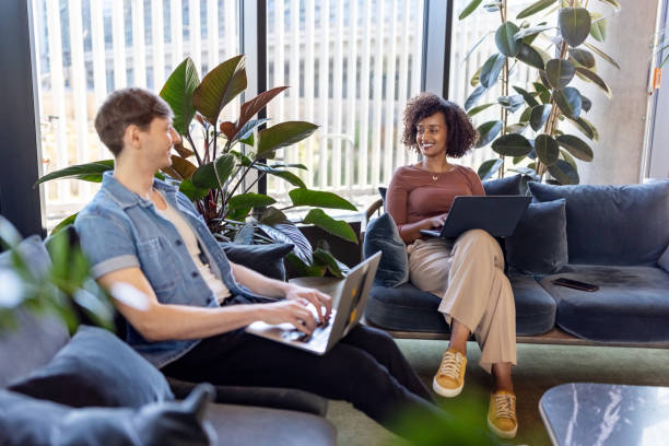 istock Two professionals discussing work at startup office lobby 1450789081