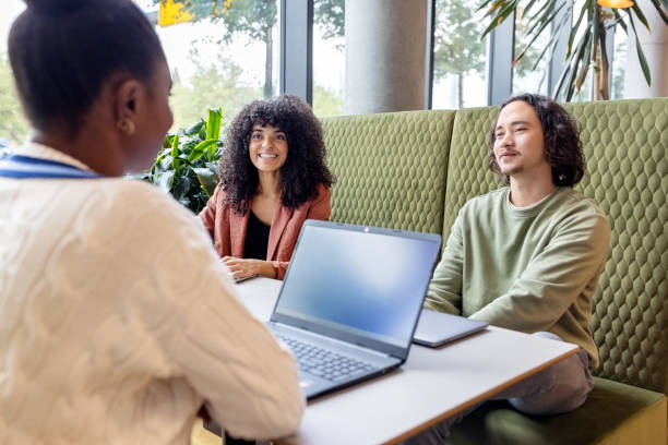 istock Diverse startup professionals talking sitting in office cafeteria 1450789091
