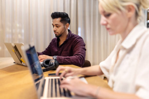 istock Man busy working on laptop at coworking office 1450789111