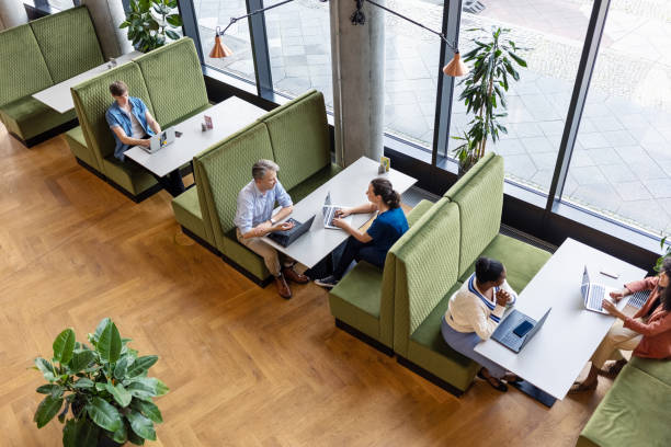 Business people with laptops working at a restaurant