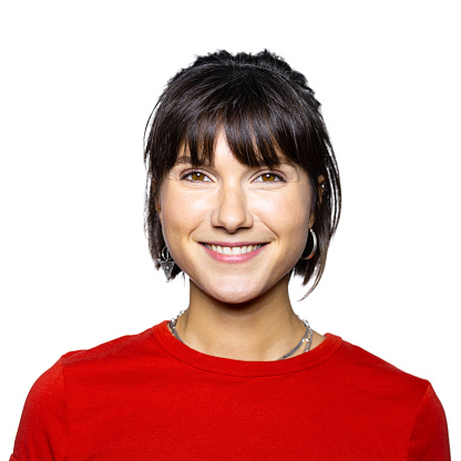 Close-up portrait of smiling young woman in studio. Happy caucasian female in red t-shirt looking at camera isolated on white background