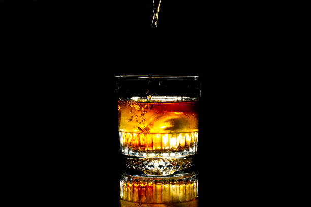 istock glass cup with whiskey on a black background 1450790830