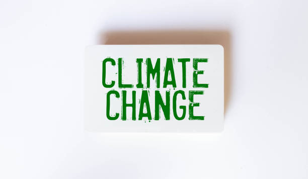 istock Ecological concept. The puzzles depict soil, next to a black surface with the text - Climate Change. 1450795017