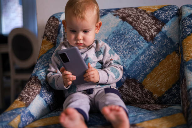 istock Baby looking at the smartphone 1450797057