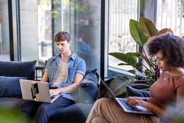 istock Diverse business people working on laptops at the creative office lobby 1450801642