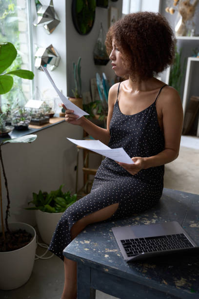 istock Busy young lady florist working from her cozy home 1450804064