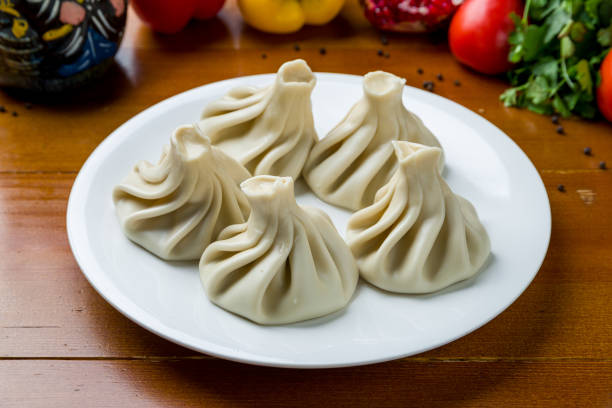 istock Khinkali with lamb on white plate on wooden table 1450806267