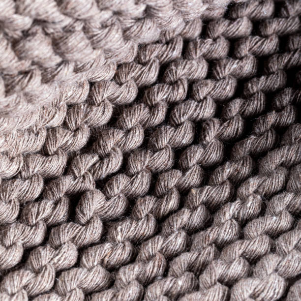 istock Detail of the handmade knitted pattern. Selective focus. Background and texture. 1450806499