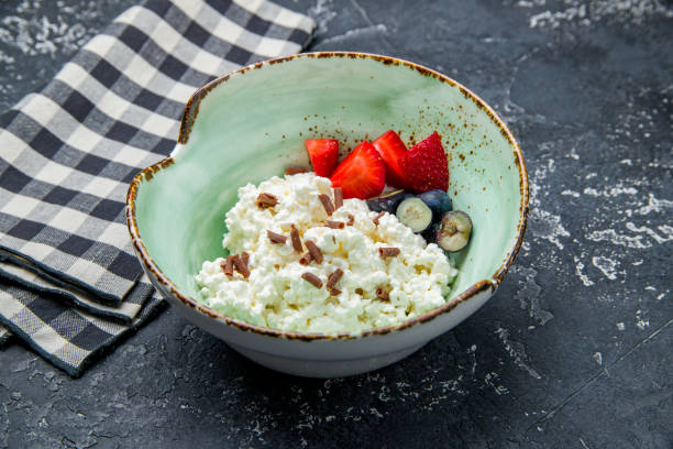 istock cottage cheese with fresh berries on dark stone table 1450809302