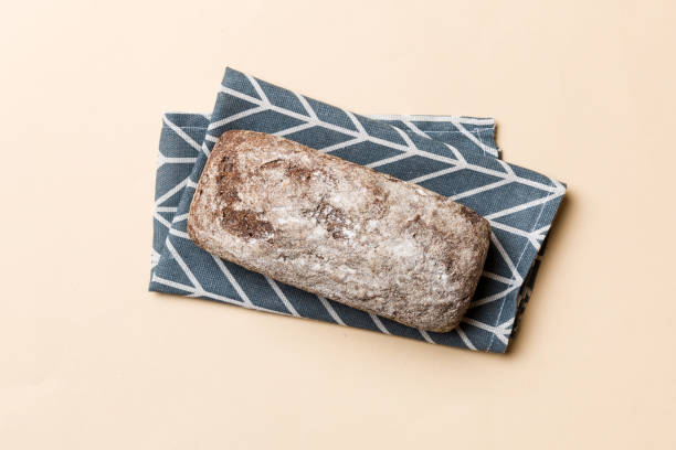 istock Fresh rye bread on napkin on rustic background, fresh bread top view 1450809637