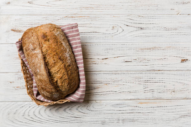 istock Freshly baked bread on basket against natural background. top view bread copy space 1450809655