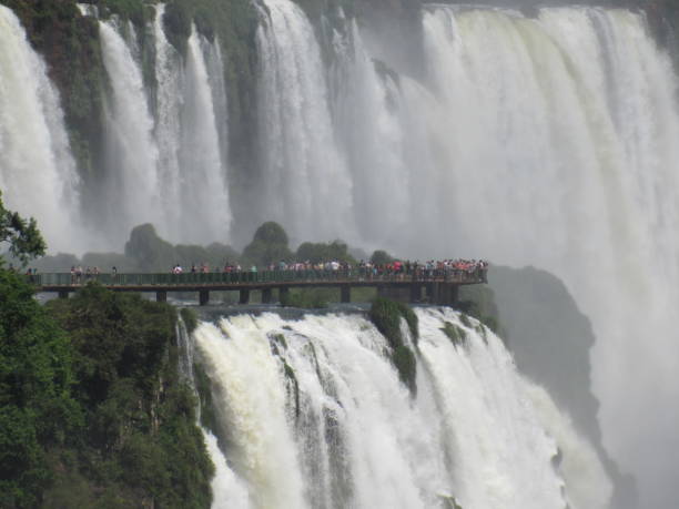 istock People admiring waterfall on Brazil side seen from Argentina side. 1450809659
