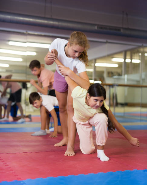 istock Young boys and girls on group self-protection training 1450811595