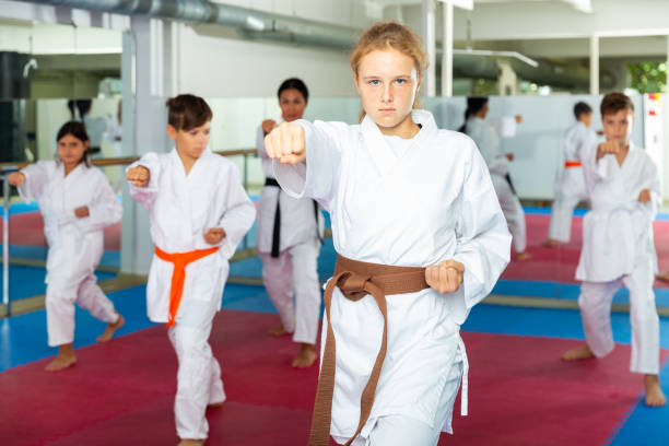 istock Girl in kimono posing during karate group training 1450811614