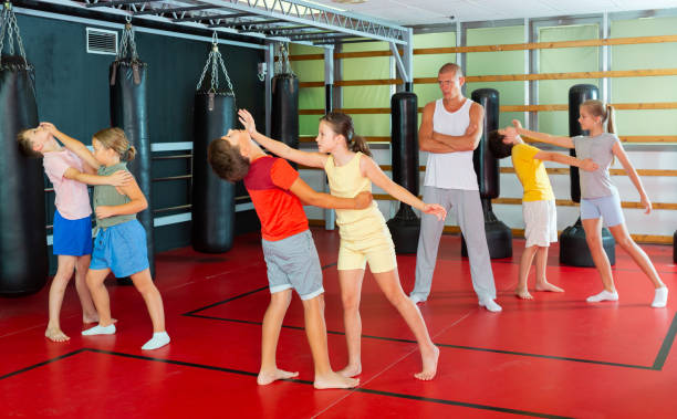 istock Kids in pair exercising self-defense movements 1450811657